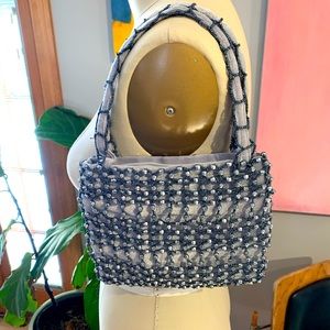 Iridescent grey all-over beaded velvet bag with straps.